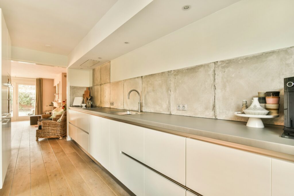 a kitchen with white cabinets and stainless steel counter tops