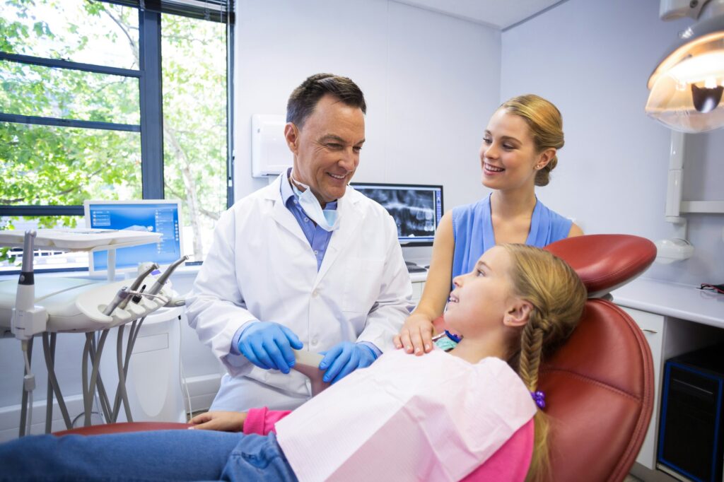 Dentist interacting with young patient