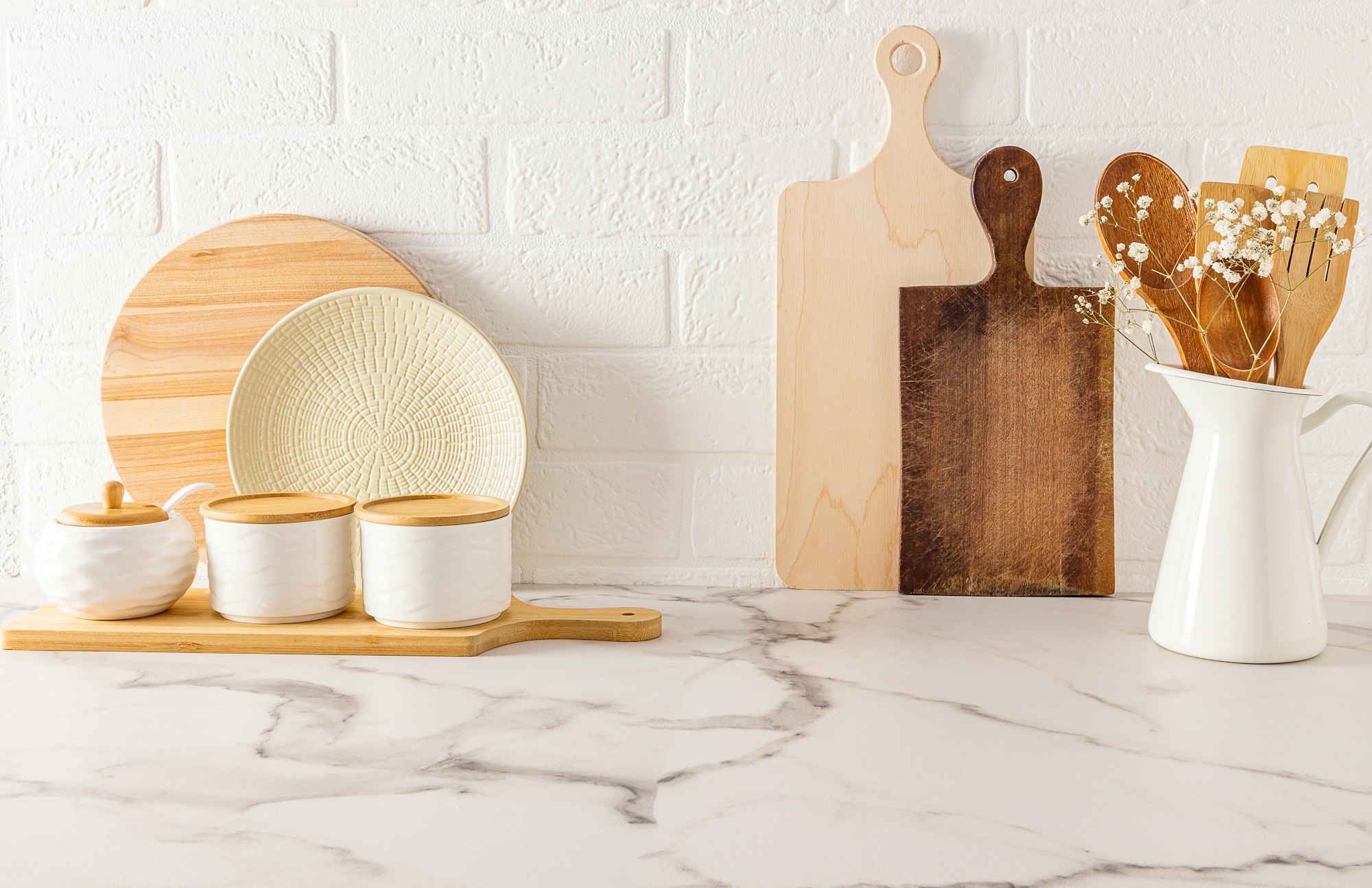 eco-friendly kitchen items on the kitchen countertop against the white brick wall.