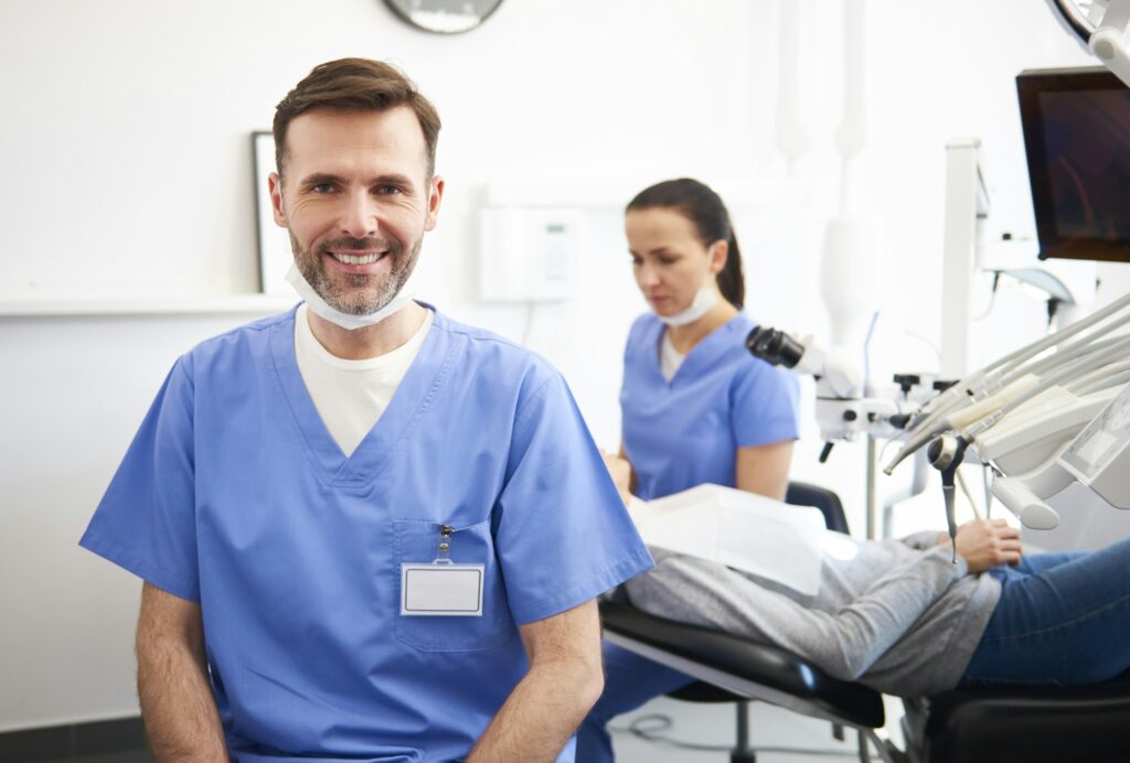 Portrait of smiling male dentist in dentist's clinic