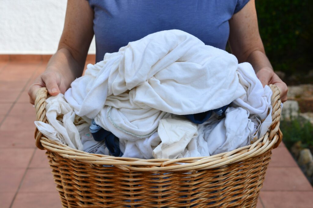 Laundry, carrying basket of wet laundry