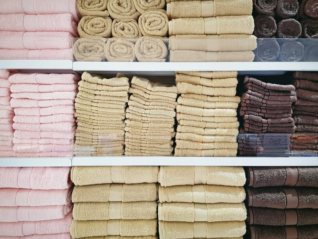 Stacked Soft Fluffy Towels on Shelves at Clothing Store