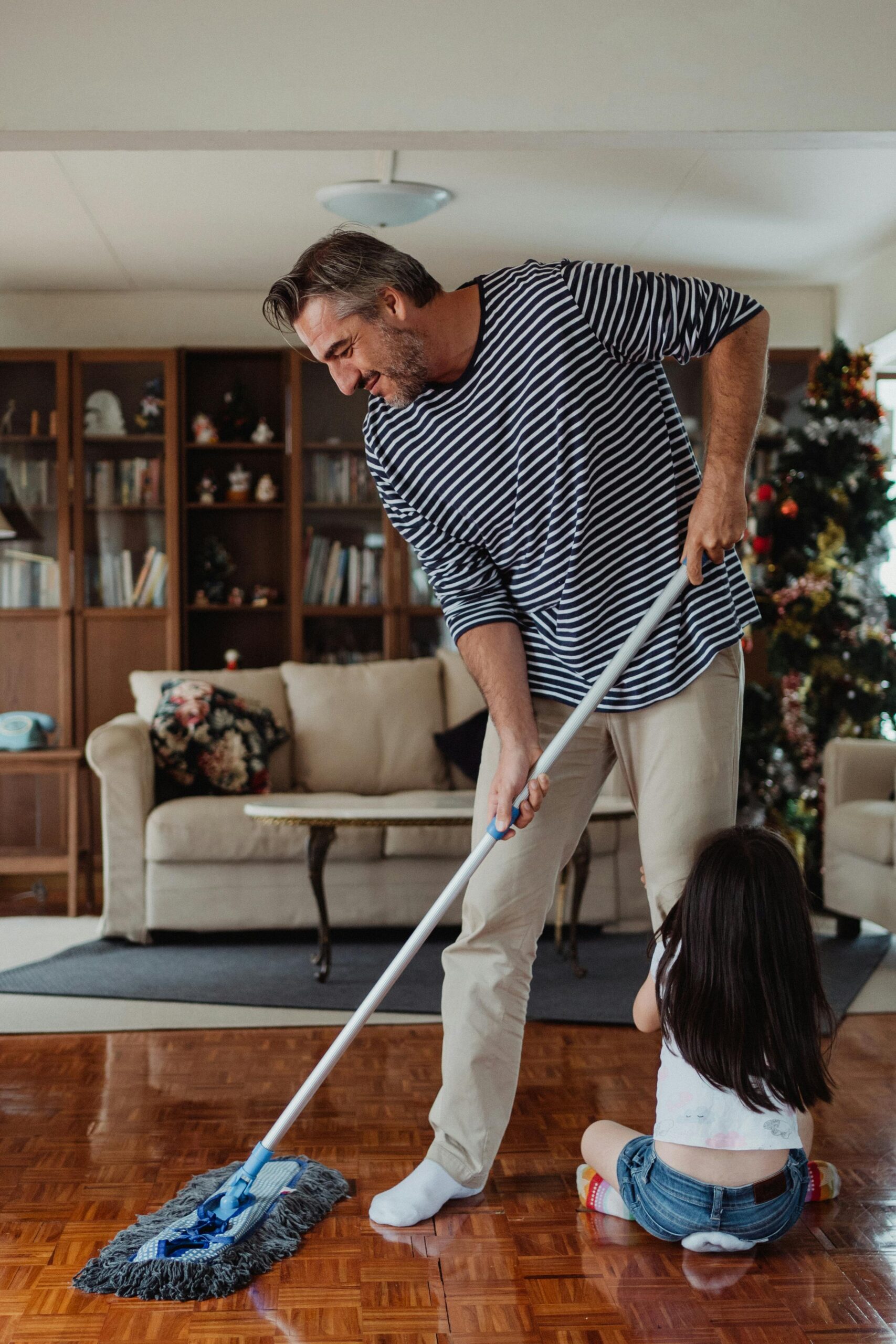 Father Sweeping the floor during the holidays