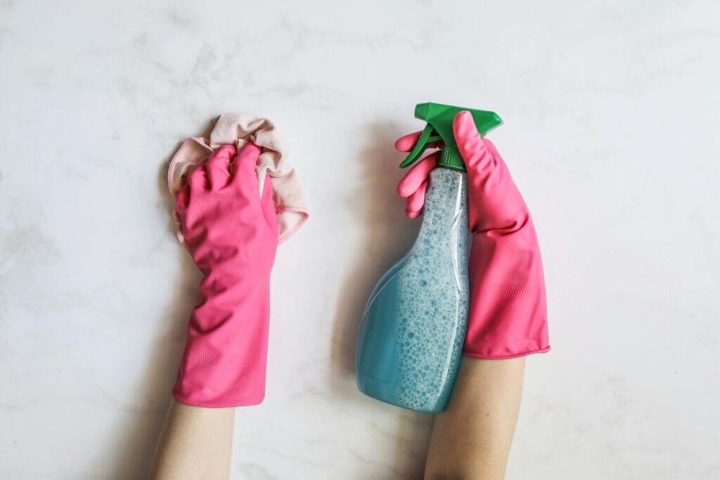 Women cleaning surface with cleaner